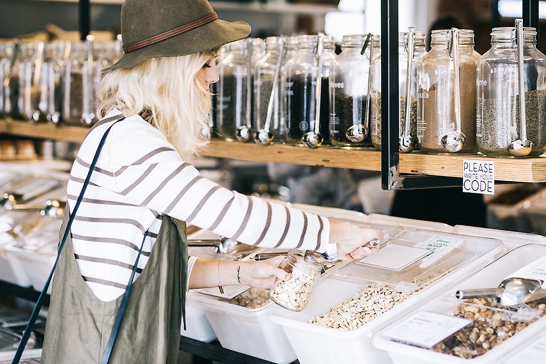 A girl fills up from the bulk food bins at GoodFor